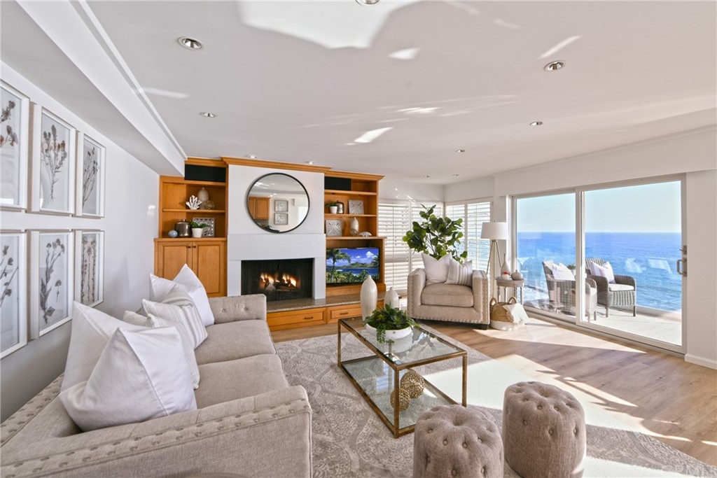 a living room with fireplace furniture and a large window