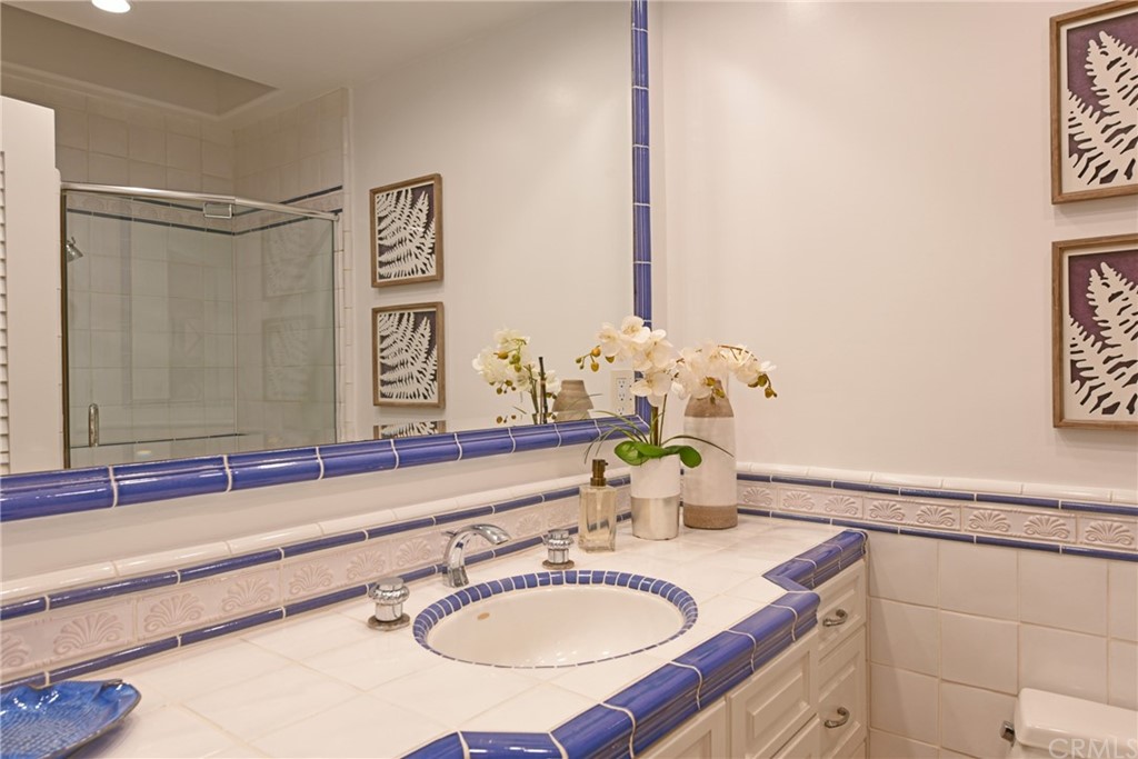 267 Avenida Lobeiro, Unit E San Clemente, CA 92672 - Photo 29 of 56 a bathroom with a sink and a mirror