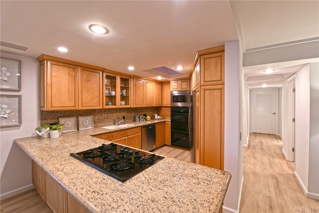 267 Avenida Lobeiro, Unit E San Clemente, CA 92672 - Photo 36 of 56 a kitchen with stainless steel appliances granite countertop a stove a sink and a refrigerator