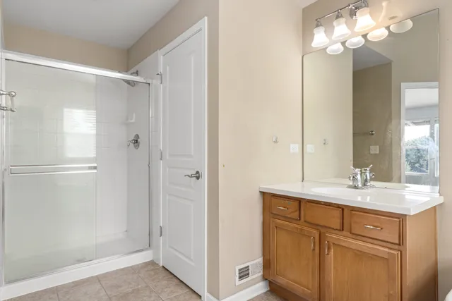 a bathroom with a sink vanity and a mirror