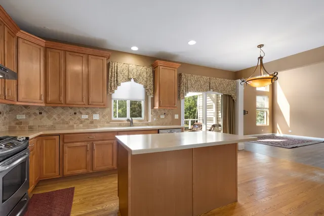 a kitchen with stainless steel appliances granite countertop wooden cabinets a sink and dishwasher