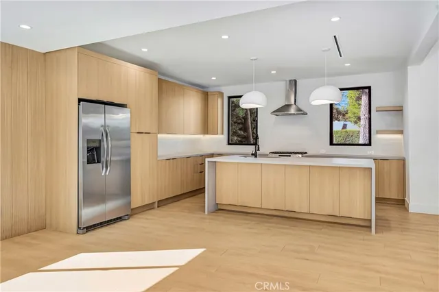a kitchen with stainless steel appliances a stove and a refrigerator