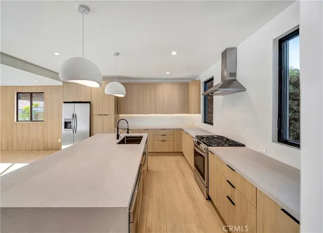 a kitchen with a stove and a wooden floor