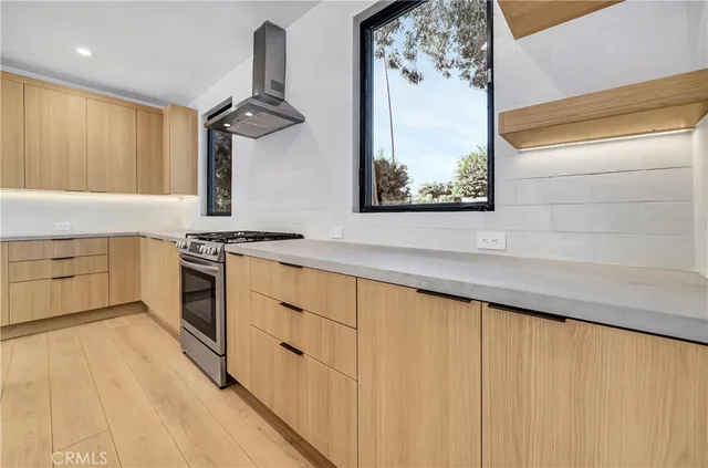 a kitchen with stainless steel appliances granite countertop a stove and a sink