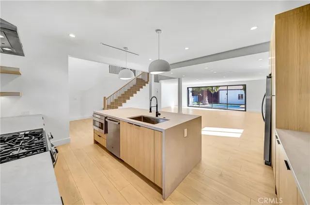 a kitchen with a sink stainless steel appliances and cabinets