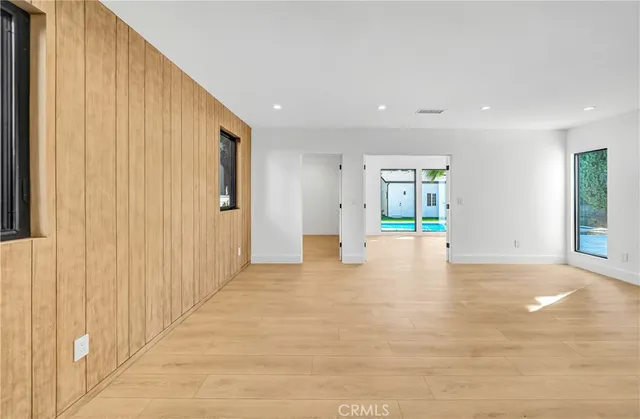 a view of an empty room with glass door and balcony