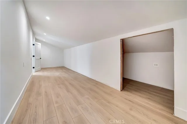 a kitchen with stainless steel appliances a stove a sink a microwave a refrigerator a window and cabinets