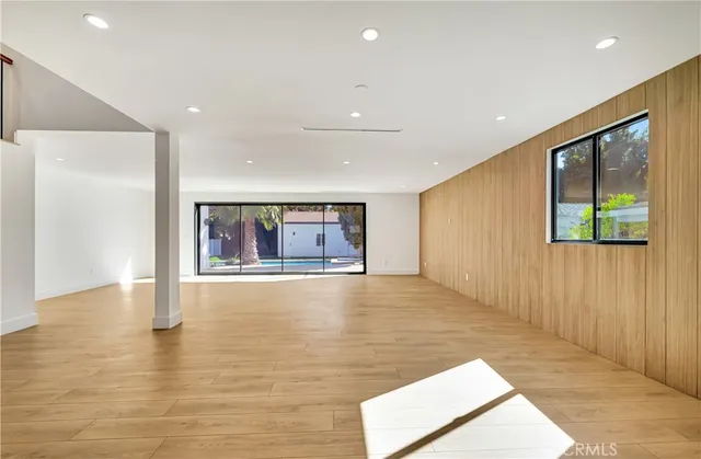 a view of a room with an empty space and balcony