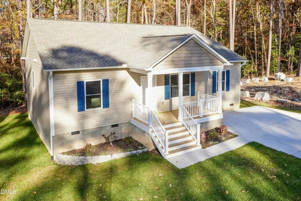 a front view of a house with a yard table and chairs
