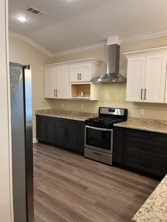 a kitchen with stainless steel appliances granite countertop a stove and a refrigerator