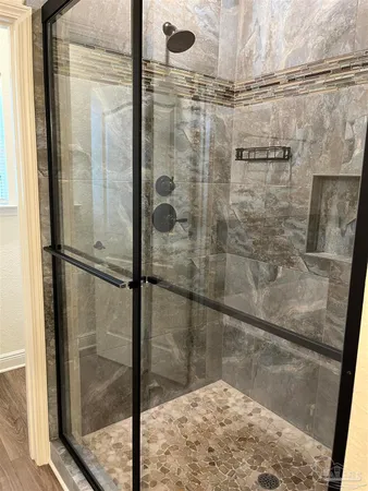 a bathroom with a glass shower door