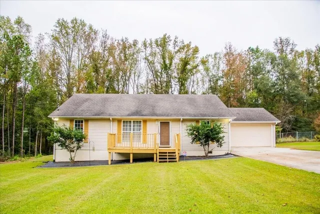 a front view of a house with a garden and plants