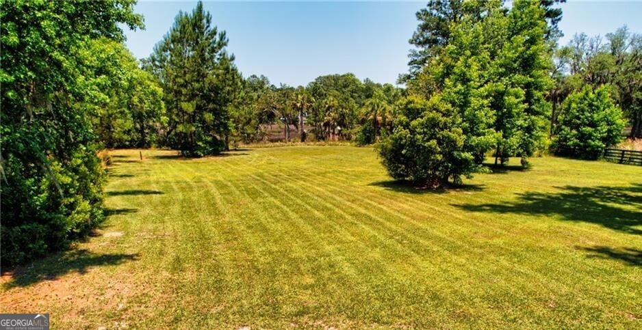 1143 River Oaks Road Brunswick, GA 31523 - Photo 1 of 4 a view of a yard with trees
