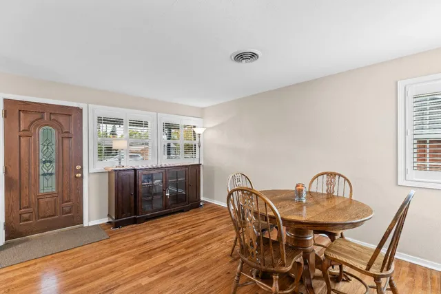 a view of a dining room with furniture and window