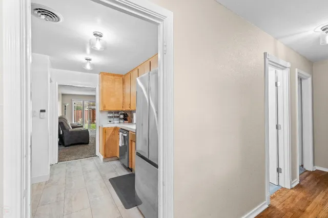 a view of a kitchen with a sink refrigerator and a window
