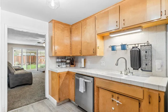 a kitchen with stainless steel appliances granite countertop a sink and a cabinets