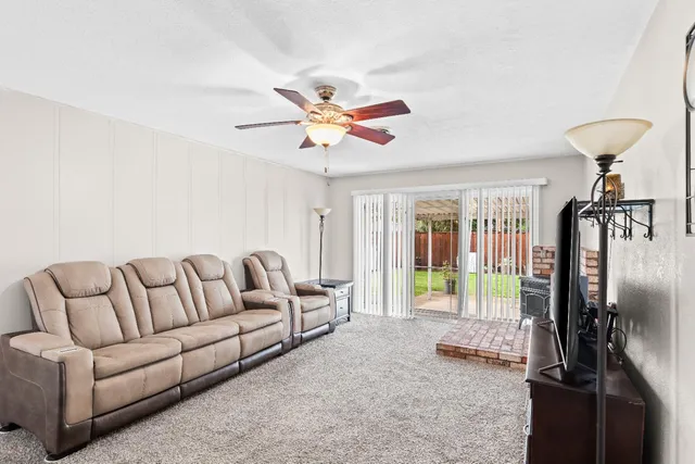 a living room with furniture and a chandelier