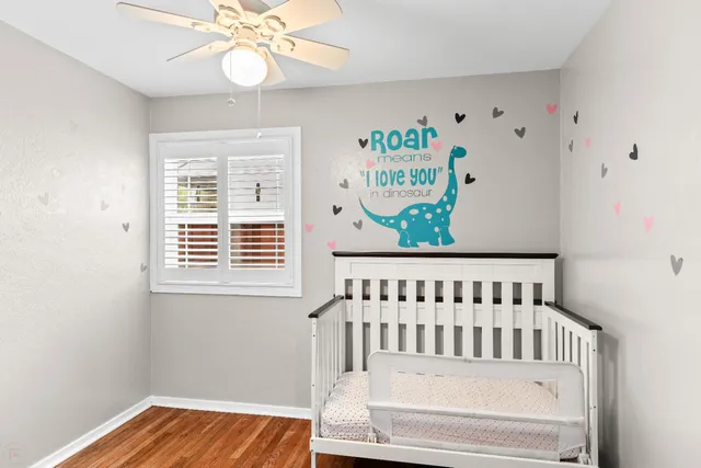 a room with a wooden floor and shelf