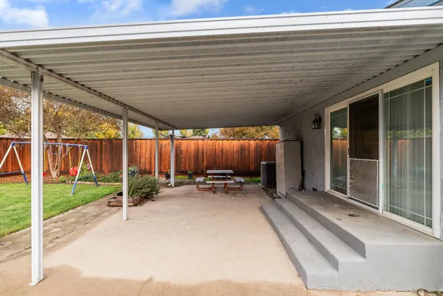 a view of a backyard with chairs and a small yard