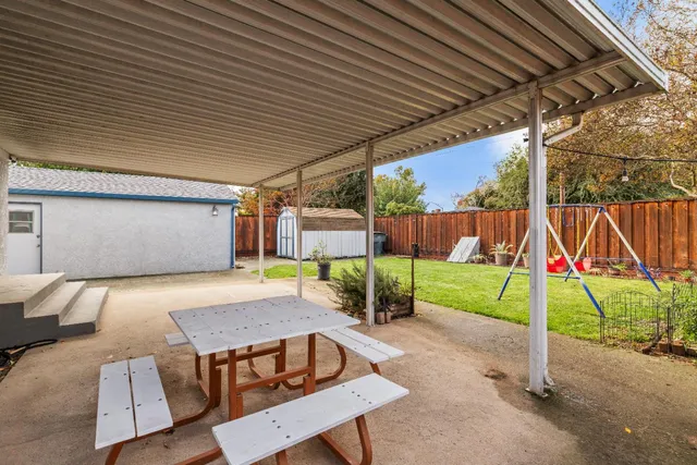 a view of a backyard with wooden fence