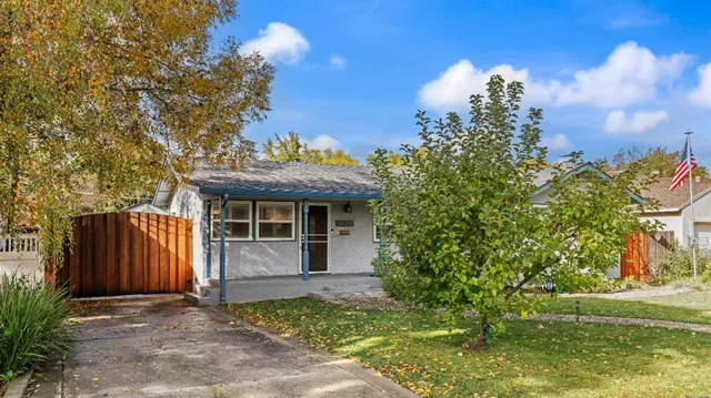 a view of a house with a yard and tree s