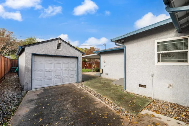 a view of a house with a wooden fence