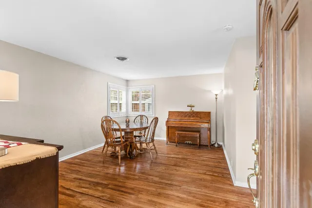 a dining room with furniture and wooden floor