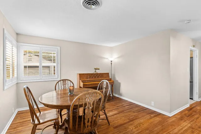 a view of a dining room with furniture and window