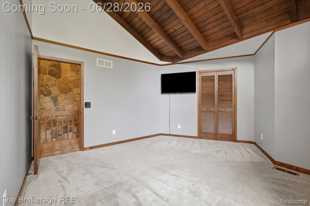 8475 Knox Road Clarkston, MI 48348 - Photo 44 of 71 Vaulted wood-beamed ceiling with light gray walls and light-toned carpet