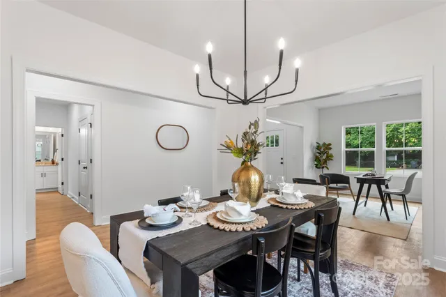 a view of a dining room with furniture wooden floor and chandelier