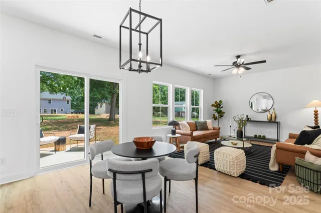 a living room with furniture a window and a chandelier