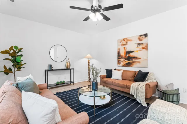 a living room with furniture and a chandelier