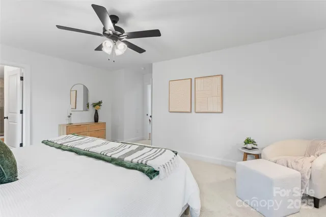 a bedroom with a bed and ceiling fan
