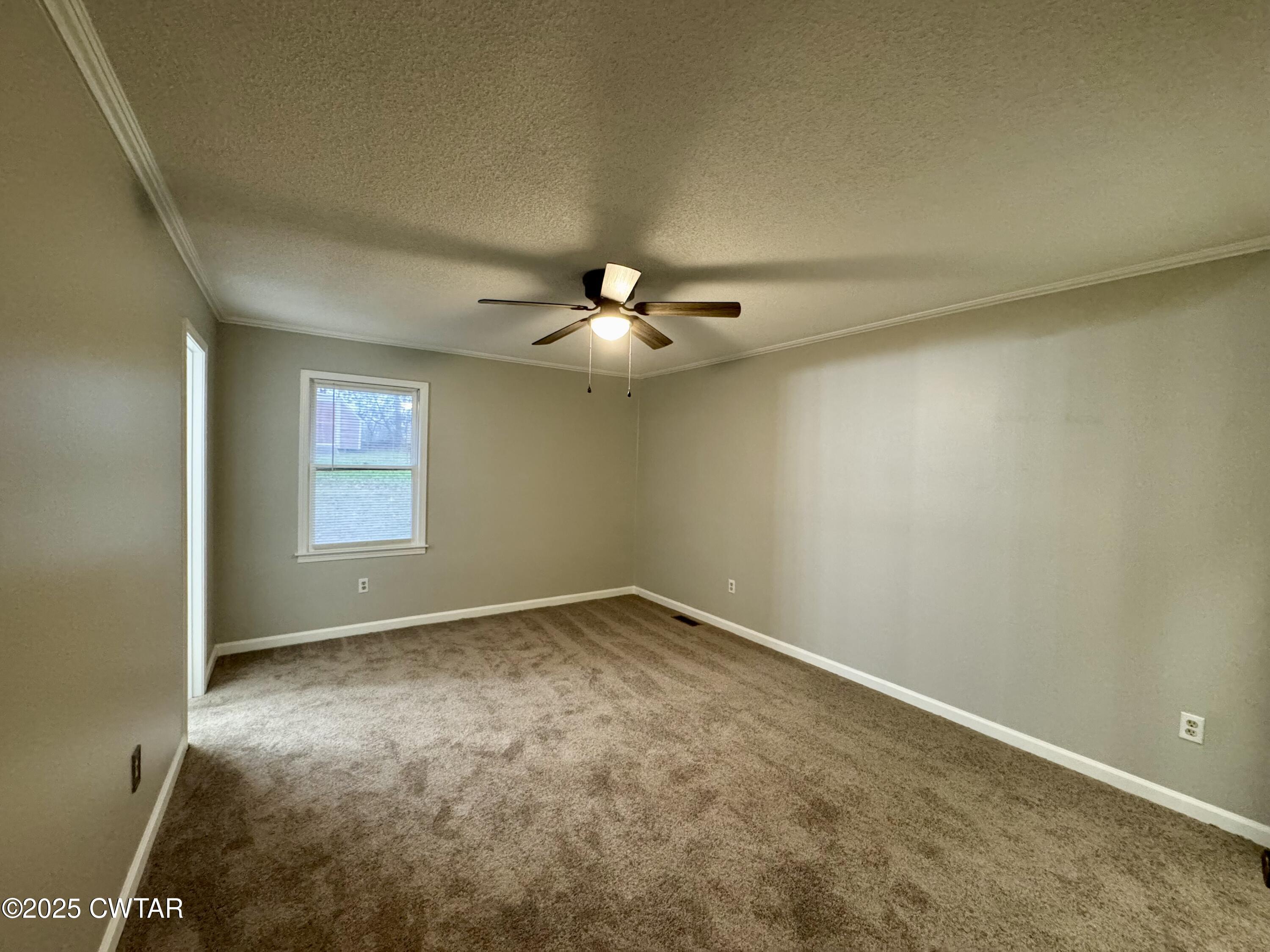 212 Fox Run Drive Jackson, TN 38305 - Photo 13 of 32 an empty room with windows and chandelier fan