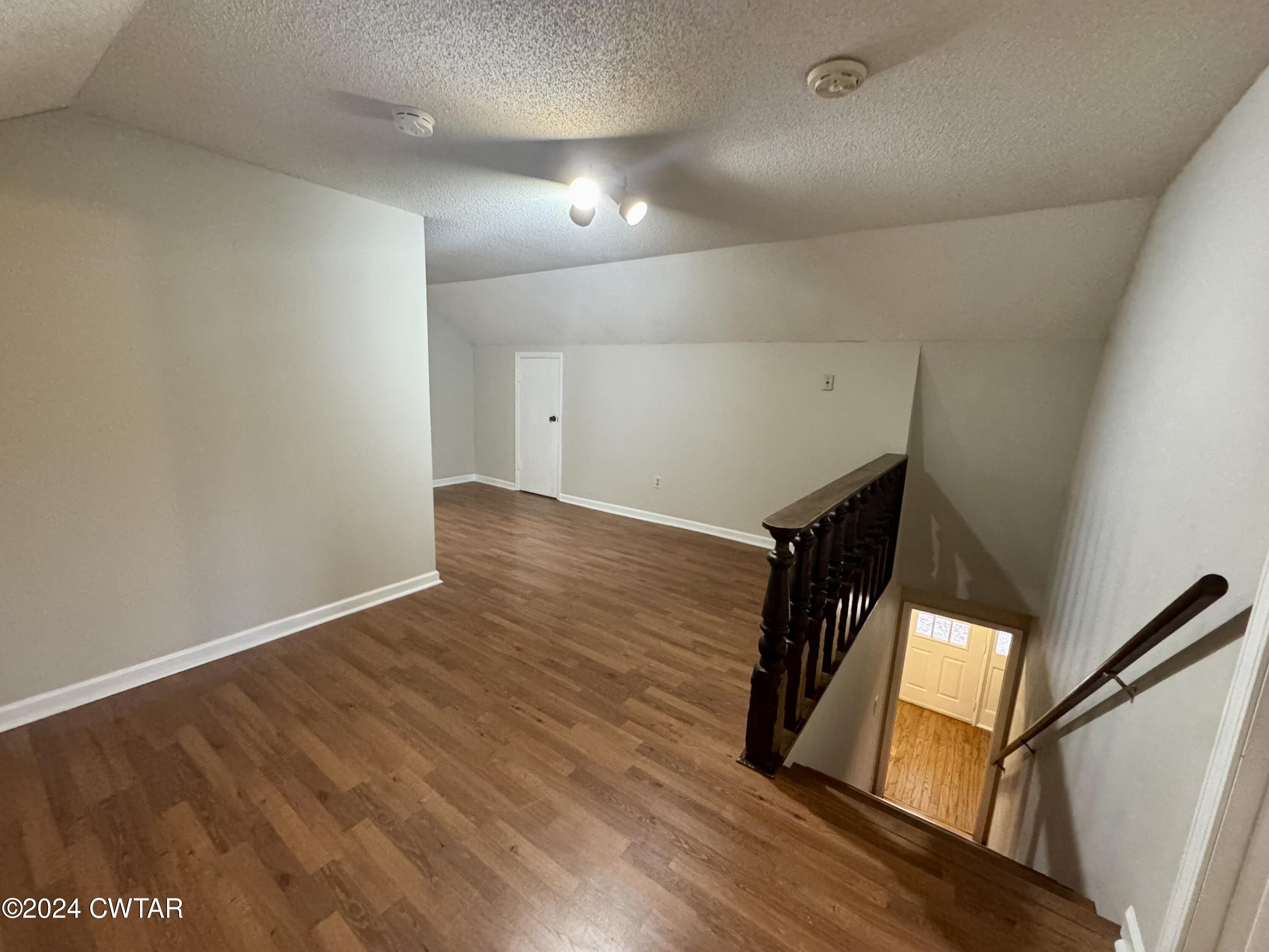 212 Fox Run Drive Jackson, TN 38305 - Photo 20 of 32 a view of an empty room with wooden floor and stairs