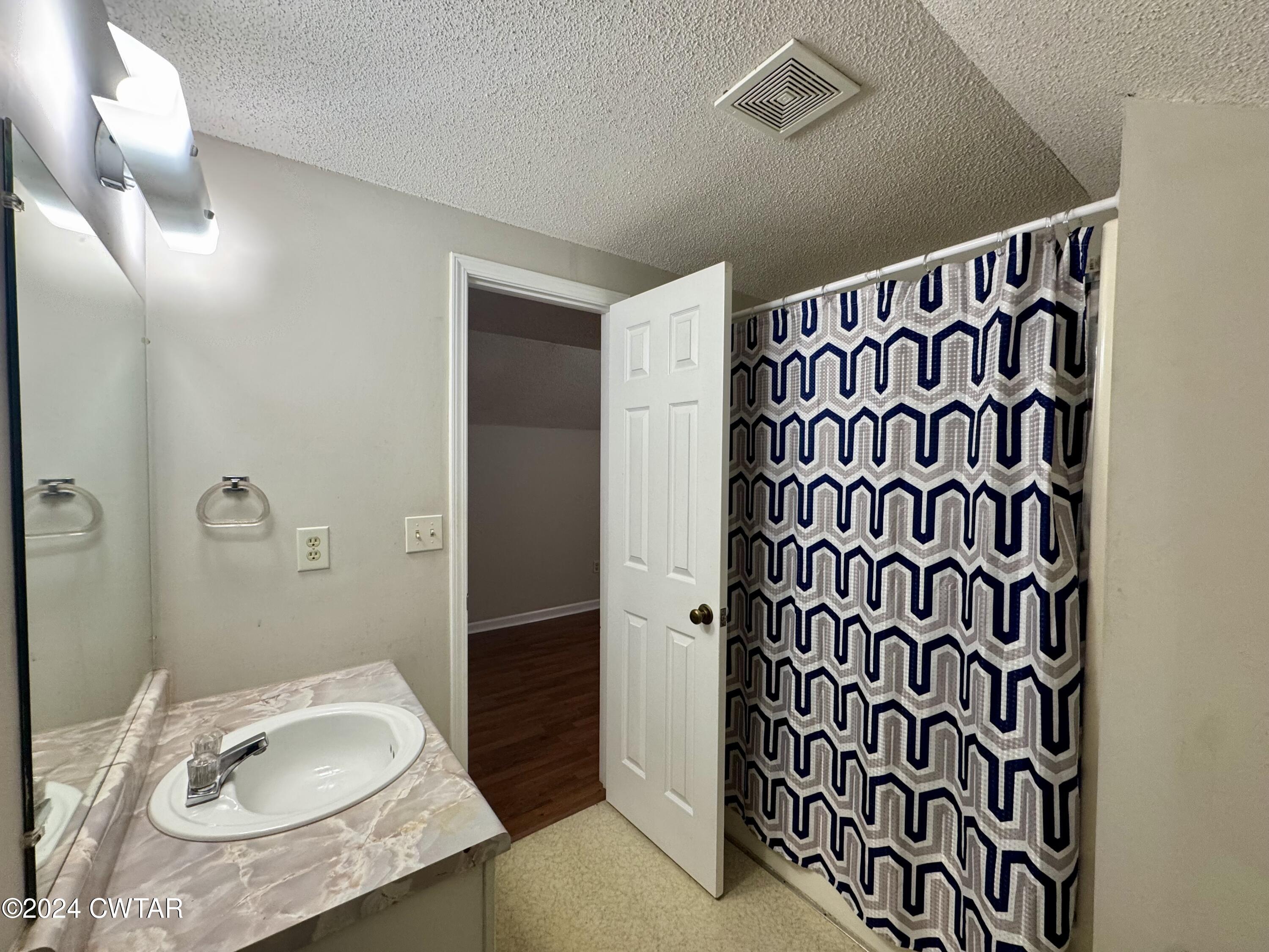212 Fox Run Drive Jackson, TN 38305 - Photo 23 of 32 a bathroom with a sink toilet and shower