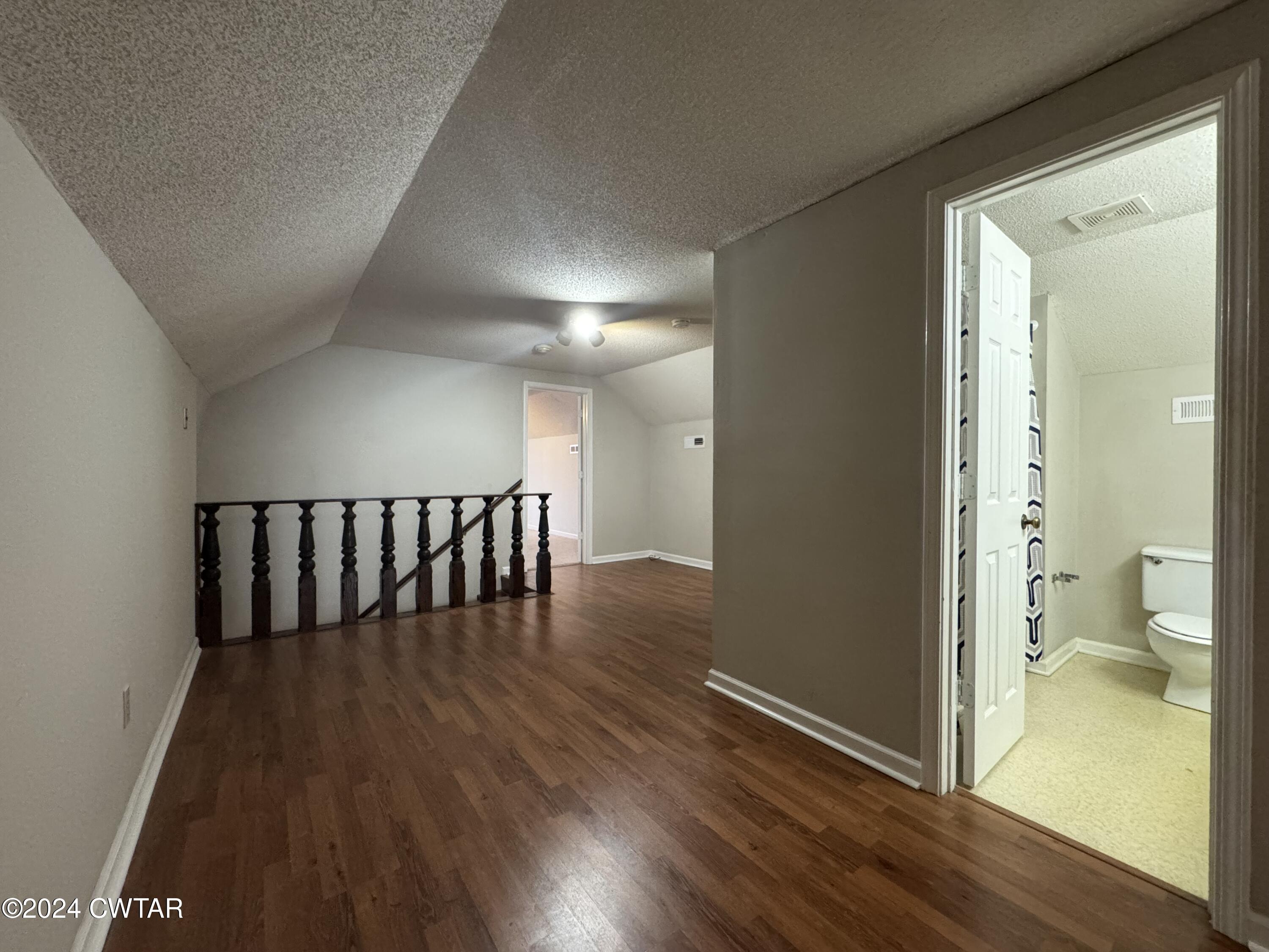 212 Fox Run Drive Jackson, TN 38305 - Photo 24 of 32 a view of a hallway with wooden floor and a bathroom