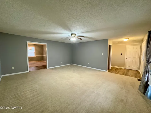 an empty room with closet and chandelier fan