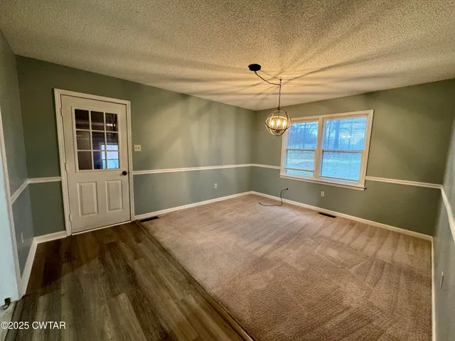 a view of a room with window and chandelier