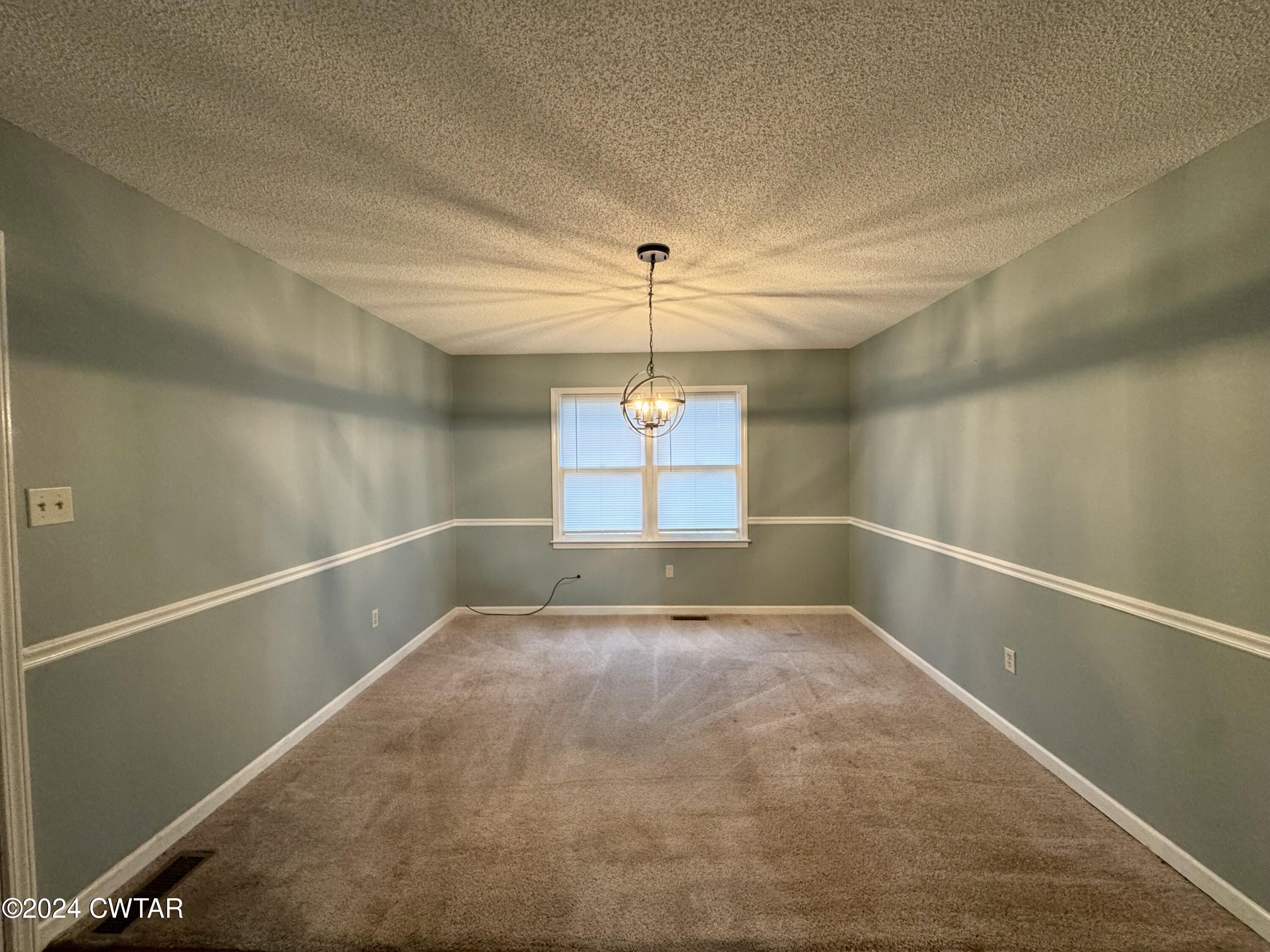 212 Fox Run Drive Jackson, TN 38305 - Photo 10 of 32 a view of a room with window and chandelier