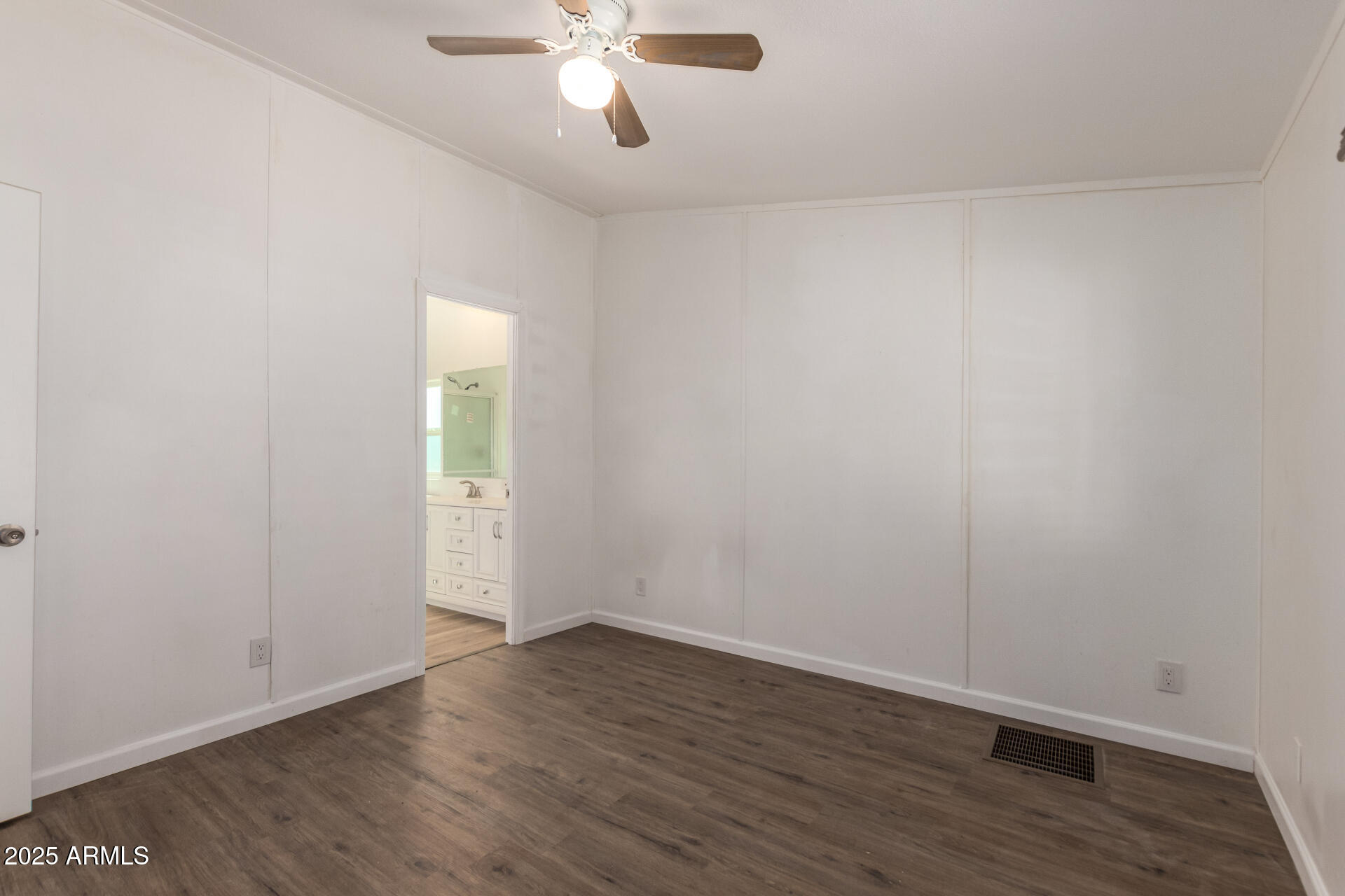 2388 South Vista Road Apache Junction, AZ 85119 - Photo 17 of 34 an empty room with wooden floor and windows