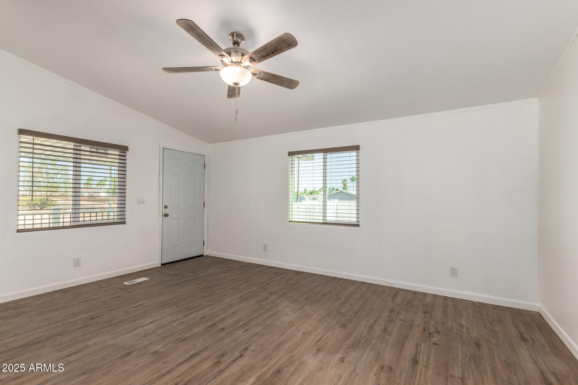 2388 South Vista Road Apache Junction, AZ 85119 - Photo 9 of 34 a view of an empty room with wooden floor and a window