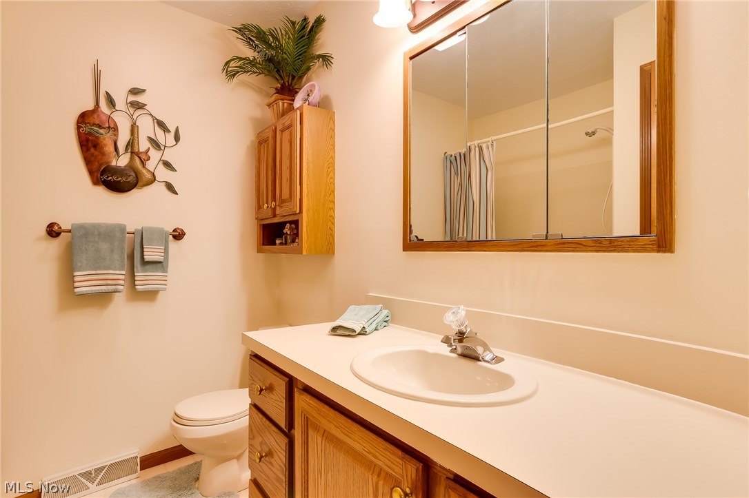 8433 Hendricks Road Mentor, OH 44060 - Photo 21 of 31 Second full bath conveniently located on the second floor has oak cabinetry and neutral counters.