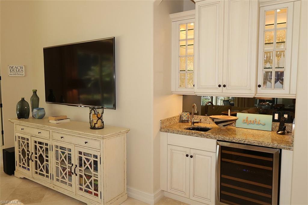 1824 Crayton Road Naples, FL 34102 - Photo 12 of 37 a kitchen with stainless steel appliances granite countertop a sink stove and cabinets