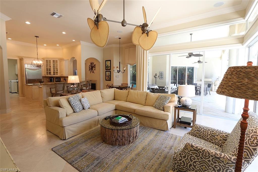 1824 Crayton Road Naples, FL 34102 - Photo 13 of 37 a living room with furniture a rug and white walls