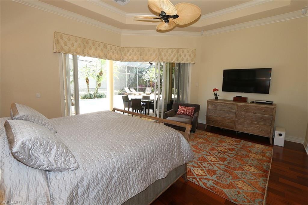 1824 Crayton Road Naples, FL 34102 - Photo 17 of 37 a spacious bedroom with a bed and a flat screen tv