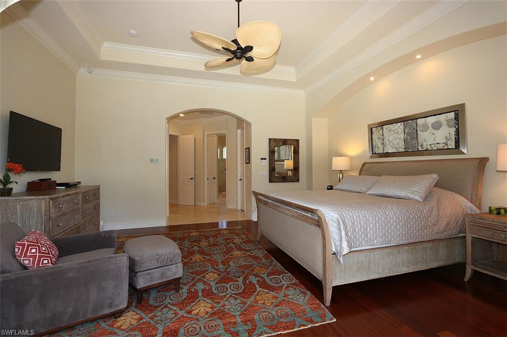 1824 Crayton Road Naples, FL 34102 - Photo 18 of 37 a spacious bedroom with a bed and a couch