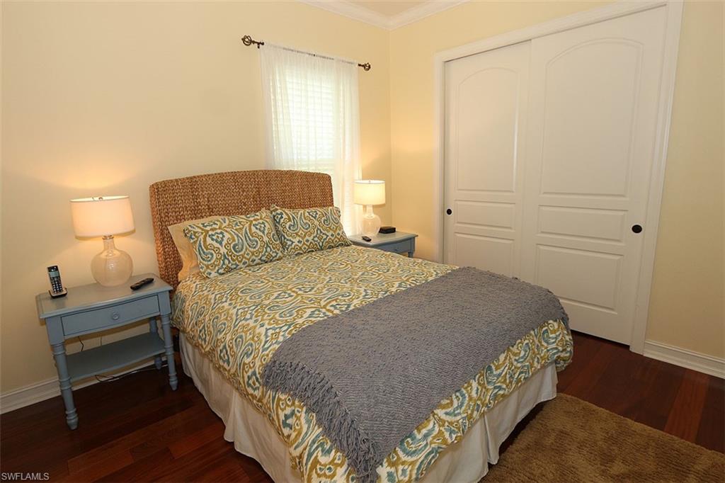 1824 Crayton Road Naples, FL 34102 - Photo 20 of 37 a bedroom with a bed and a lamp