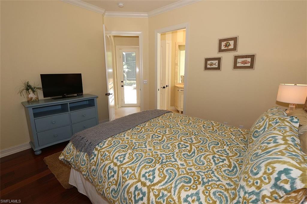 1824 Crayton Road Naples, FL 34102 - Photo 21 of 37 a bedroom with a bed and a flat screen tv