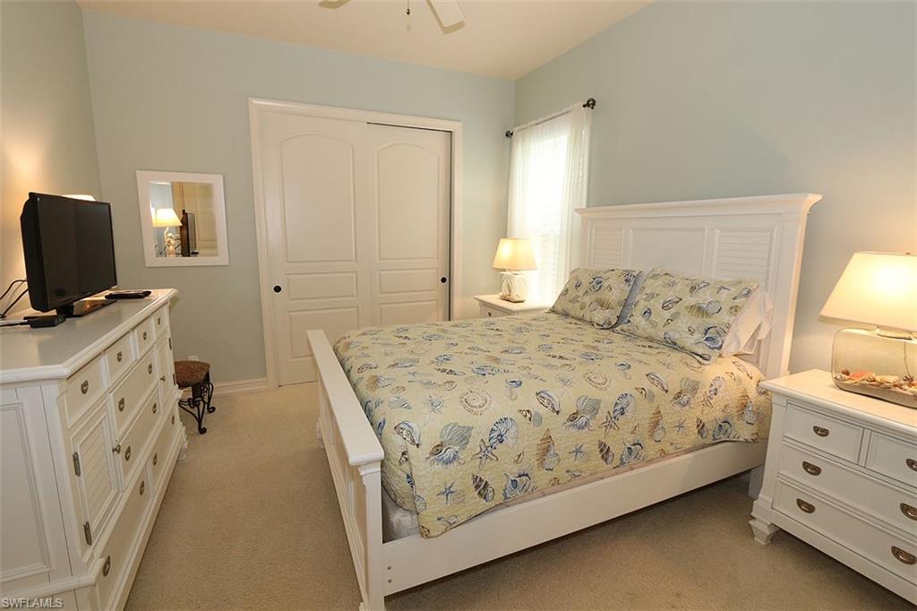 1824 Crayton Road Naples, FL 34102 - Photo 25 of 37 a bedroom with a bed and a flat screen tv